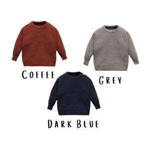 three baby sweater showing the choice of colors coffee grey and dark blue