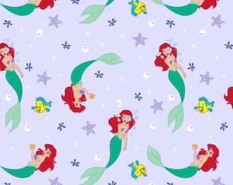 May include: A purple background with a repeating pattern of Ariel the Little Mermaid, a yellow fish, and purple starfish. Ariel is depicted with red hair, a green tail, and a seashell bra. She is holding a pearl in her hand.