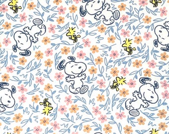 May include: White fabric with a repeating pattern of blue leaves, pink and orange flowers, and cartoon images of Snoopy and Woodstock.