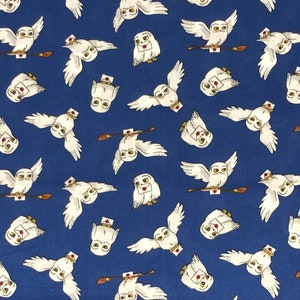 May include: A blue fabric with a repeating pattern of white owls carrying letters. The owls are flying in different directions and have a whimsical look.