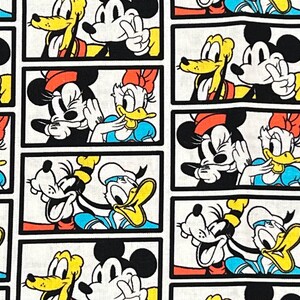 May include: Fabric featuring a repeating pattern of cartoon characters in rectangular frames. Mickey Mouse, Minnie Mouse, Donald Duck, Daisy Duck, and Pluto are depicted in various poses, with bright colors on a white background.
