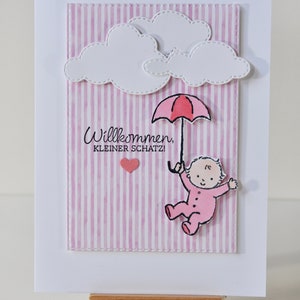 Cartão de nascimento "Bebê cai das nuvens com guarda-chuva/Bem-vindo, querido", rosa