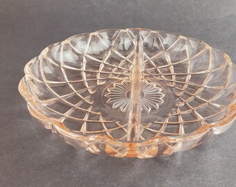 Divided pink depression glass relish dish with two sections, diamond pattern and scalloped rim