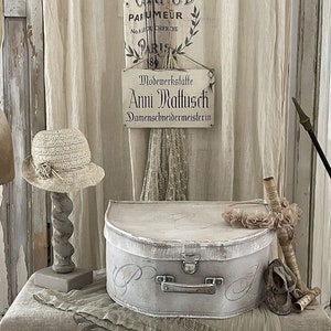 Old rounded vintage suitcase***