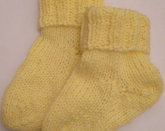 hand-knitted baby socks, yellow