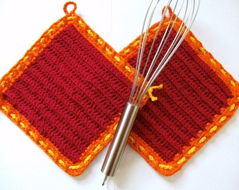 red pot holders with an orange border and a yellow cord