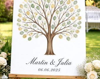May include: A white rectangular guest book sign featuring a brown tree illustration with green and gold fingerprint leaves. The text reads Martin & Julia and the date 06.06.2025 in a black serif font. The sign is displayed on a wooden easel.