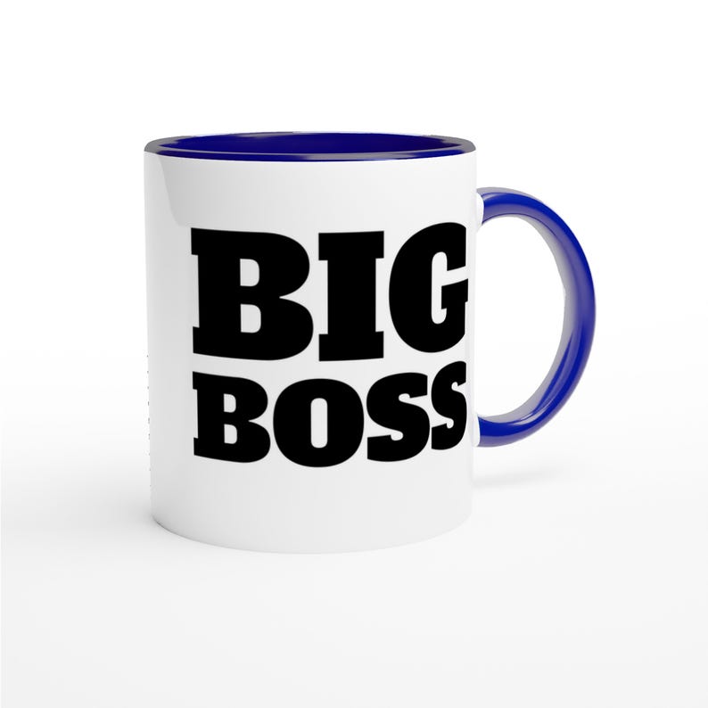 May include: White ceramic mug with a navy blue interior and handle. The mug features the words "BIG BOSS" in bold, black letters. The mug is designed for hot or cold beverages.