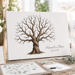 May include: A canvas print featuring a watercolor illustration of a bare tree with intertwined trunk and branches. The names "Hannah & Marco" and the date "23.05.2026" are written in elegant script. The artwork is displayed on a wooden surface.