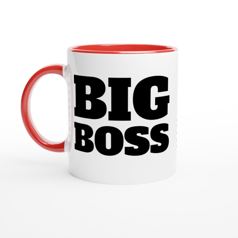 May include: White ceramic mug with a red interior and handle. The mug features the words "BIG BOSS" in bold, black letters. The mug is designed for hot beverages.