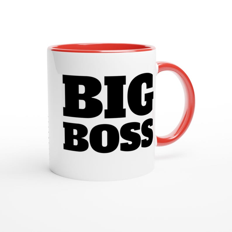 May include: White ceramic mug with a red interior and handle. The mug features the words "BIG BOSS" in bold, black letters. A simple, yet bold design for a coffee or tea cup.