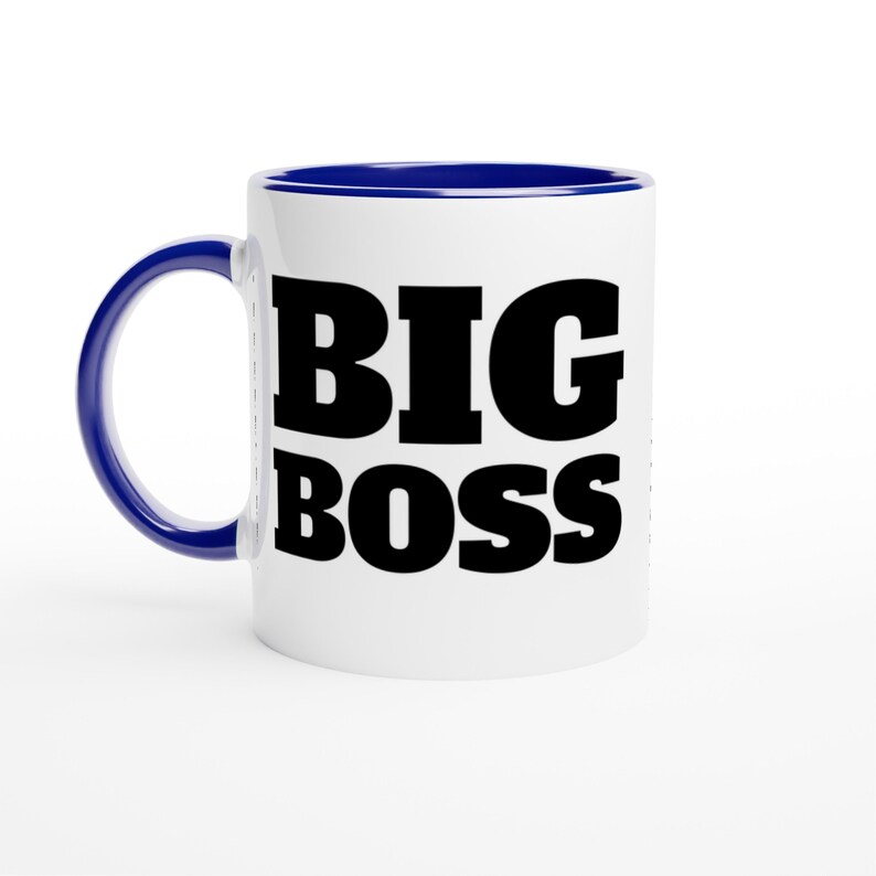 May include: White ceramic mug with a blue interior and handle. The mug features the words "BIG BOSS" in bold, black capital letters. The mug is designed for hot beverages.