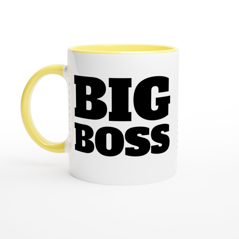May include: White ceramic mug with a yellow handle and interior. The mug features the words "BIG BOSS" in bold, black capital letters, making it a perfect gift for a boss or leader.