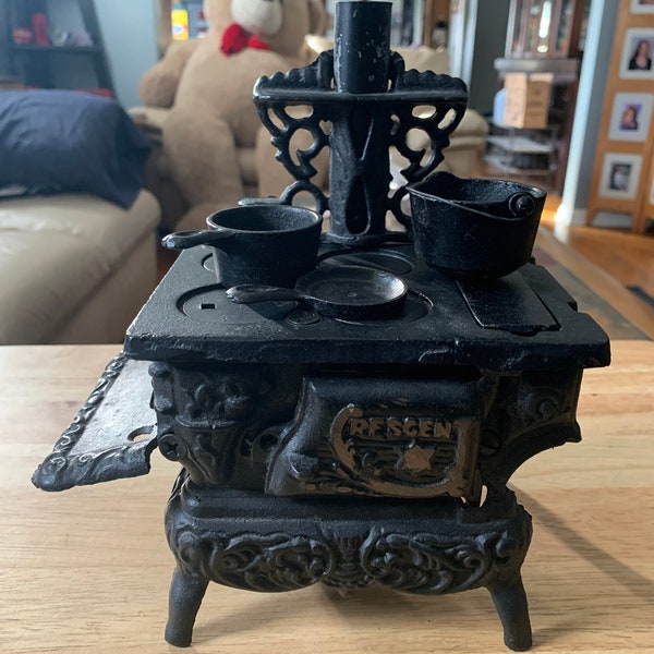 Vintage 1960s Crescent black cast iron toy cookstove right side shelf is missing accessories included