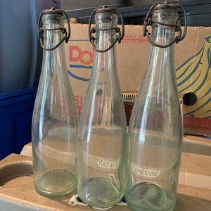 Three antique glass pop top bottles