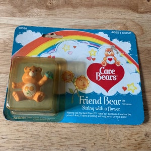 Vintage 1982 kenner Carebear friend bear miniatures sitting with a flower figure on original card sealed