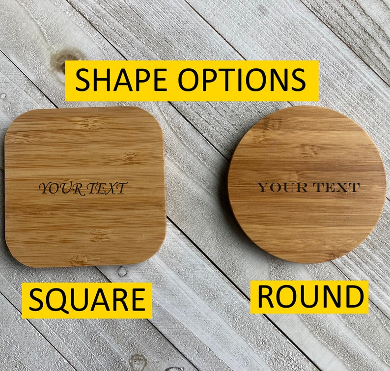 May include: Two wooden coasters, one square and one round, with the text "YOUR TEXT" engraved on each. The coasters are made of natural bamboo and have a light brown color. The coasters are displayed on a white wooden surface.