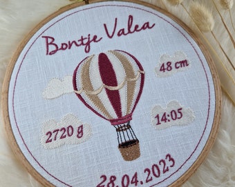 Embroidery hoop with embroidered fabric, hot air balloon, name and dates of birth