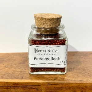 Pearl sealing wax dark red sealing wax wax in pearl shape in a glass with cork