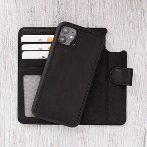 May include: Black leather phone case with a built-in card holder. The case has a flap that closes with a magnetic snap. The phone case is designed for a smartphone with a camera bump.