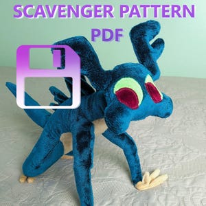 May include: A plush blue creature with red and green eyes, and cream-colored feet. The text "SCAVENGER PATTERN PDF" is displayed in purple above a floppy disk icon. The plush toy has a long neck and tail.