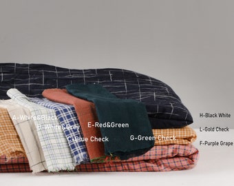 May include: A stack of eight fabric swatches in various colors and patterns, including white and black, white and gray, red and green, blue check, green check, orange check, and purple grape.