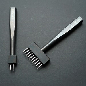 May include: Two leather craft tools, a single hole punch and a multi-hole punch. Both tools are black metal with the text "KS Made Punch" on the handles.