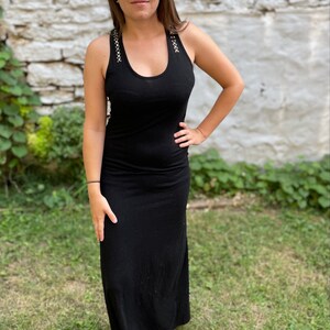 Simple, comfortable, long black dress! Floor length, has studded detail, comfy, soft. You can dress it up or down, or wear around the house.