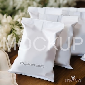 May include: A set of four white, blank, resealable pouches with a PSD/SMART OBJECT label. The pouches are on a wooden surface.