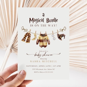 May include: A baby shower invitation with a Harry Potter theme. The invitation features a watercolor illustration of a baby onesie, a scarf, a wand, glasses, and a witch's hat hanging on a clothesline. The text reads "A Magical Bundle is on the way!" and includes the baby shower details.
