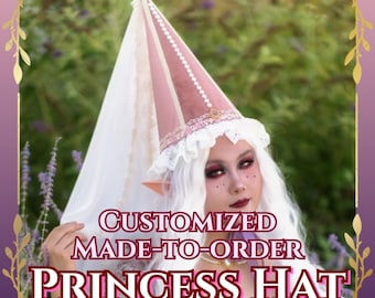 May include: A tall, conical pink velvet hat featuring a white lace trim at the base, a row of small white pearls along the side seam, and a long, sheer white veil attached to the peak. The text CUSTOMIZED MADE-TO-ORDER PRINCESS HAT is visible.
