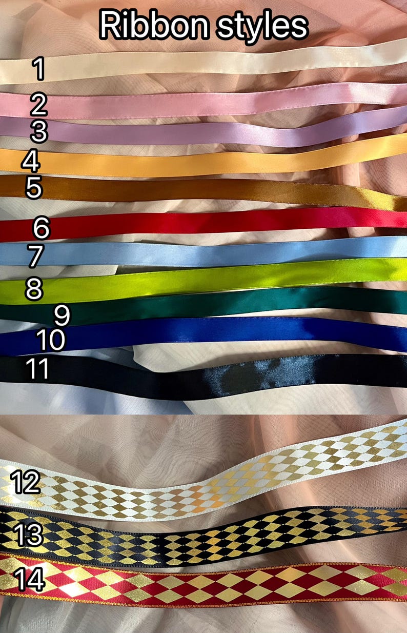 May include: A variety of ribbon styles are displayed, each with a unique color and design. The ribbons range from solid colors like cream, pink, and blue to patterned designs with gold accents. The text "Ribbon styles" is at the top.