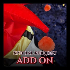 May include: A red and yellow jester hat with a black stripe and orange pom-poms. The text "SPECIAL REQUEST ADD ON" is displayed in a decorative font. The hat is made of a shiny fabric.