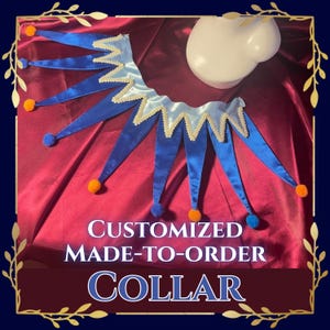 May include: A jester-style collar featuring alternating light blue and royal blue satin points, trimmed with white rickrack edging. Each point terminates in a small orange or blue pom-pom. The text CUSTOMIZED MADE-TO-ORDER COLLAR is visible.