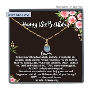 May include: A gold necklace with a light blue gemstone pendant in a black box with a floral design. The box has the text "Happy 18th Birthday" and "Emma" on it.