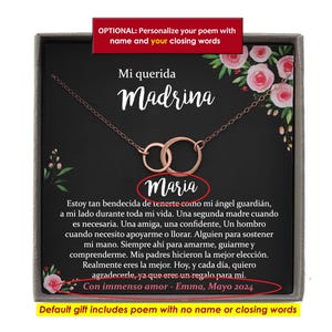 Puede incluir: Un collar de oro rosa con dos c&iacute;rculos entrelazados en una caja de regalo gris. La tarjeta presenta ilustraciones florales rosas y texto en espa&ntilde;ol que incluye Mi querida Madrina, Maria y un poema que termina con Con immenso amor - Emma, Mayo 2024.