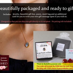 May include: A gift box containing a labradorite necklace. The box features a floral design and the words "Labradorite", "Strength, Protection and Balance", and "Be Wished". The necklace is on a gold chain and has a blue-grey labradorite stone pendant.