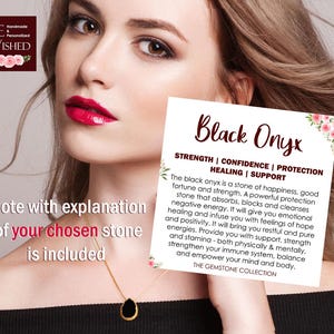 May include: A black onyx gemstone pendant necklace with a gold chain. The pendant is teardrop shaped and is surrounded by a white card with the text "Black Onyx" and a description of the stone's properties. The card also includes the text "Strength | Confidence | Protection | Healing | Support".