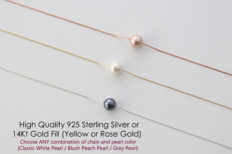 May include: Three delicate necklaces with a single pearl pendant each. The pearls are white, blush peach, and grey. The chains are silver and gold.