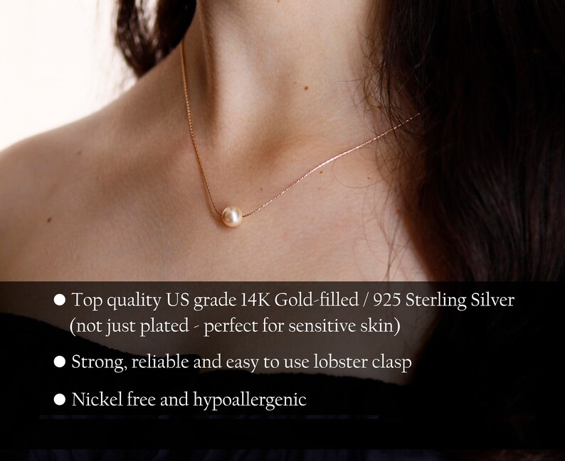 May include: A delicate gold necklace featuring a single, luminous pearl pendant. The necklace is suspended on a fine chain, creating a minimalist and elegant design. The pearl is a soft, creamy color, and the chain appears to be gold-filled.