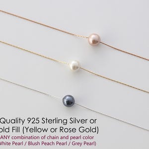 May include: Three delicate necklaces with a single pearl pendant each. The pearls are white, blush peach, and grey. The chains are silver and gold.