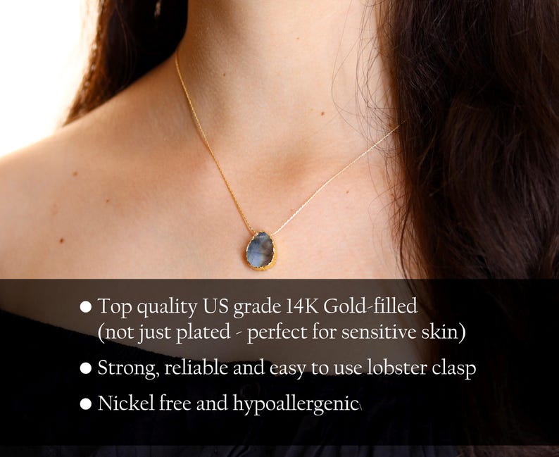 May include: A gold-filled necklace with a teardrop-shaped pendant featuring a blue and grey stone. The necklace is made with high-quality US grade 14K gold-filled material, making it perfect for sensitive skin. It features a lobster clasp and is nickel-free and hypoallergenic.