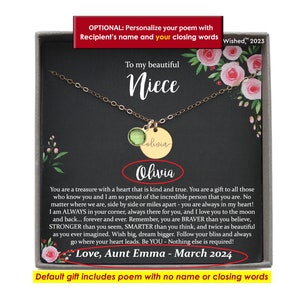 May include: A gold-tone necklace with a round green crystal pendant and a circular gold-tone disc engraved with the name Olivia. The necklace is presented on a black card featuring pink floral illustrations and a printed poem addressed to a niece.
