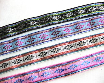 May include: Four different types of trim with a floral pattern and metallic accents. The trims are black, blue, red, and pink.