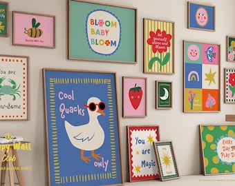 May include: A collection of framed art prints with whimsical designs. The prints feature illustrations of a bee, crab, duck, strawberry, and other playful images. Text includes "Bloom Baby Bloom", "Cool Quacks Only", and "You are Magic".