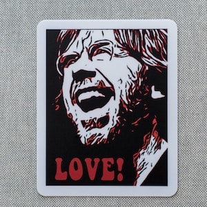 May include: A black and white illustration of a man with a beard, yelling with his mouth open. The background is black and the man is red. The text "LOVE!" is in red letters at the bottom of the image.