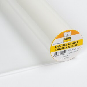 May include: A roll of transparent, glossy Lamifix fabric. The label reads "LAMIFIX GLANZ LAMIFIX GLOSS" and includes the dimensions: 45 cm x 15 m. The fabric is 100% PES.