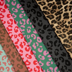 May include: A collection of colorful animal print fabrics. The fabrics feature leopard spots in various colors, including red, pink, green, and black. The fabrics are arranged diagonally, showcasing the different patterns and textures.