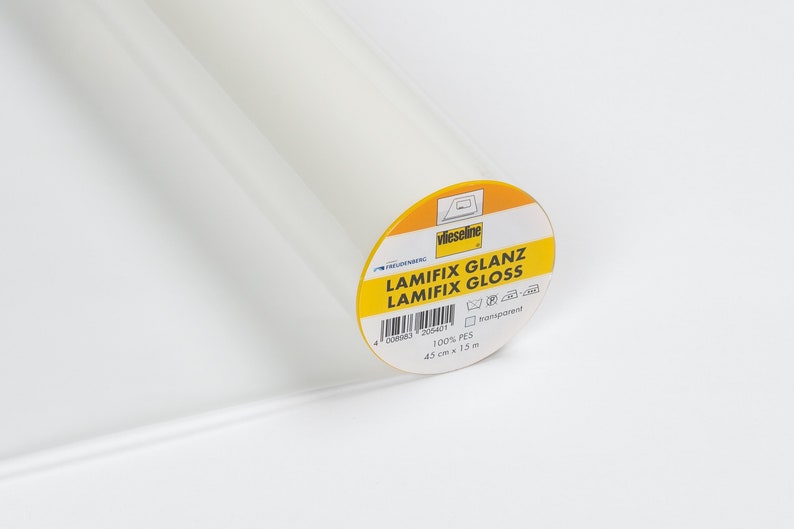 May include: A roll of transparent, glossy Lamifix fabric. The label reads "LAMIFIX GLANZ LAMIFIX GLOSS" and includes the dimensions: 45 cm x 15 m. The fabric is 100% PES.
