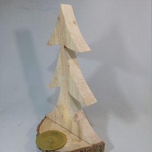sawn-out decorative fir tree with candle holder